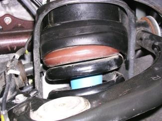 Urethane lift kit spacers that have been crushed and distorted from normal wear and tear
