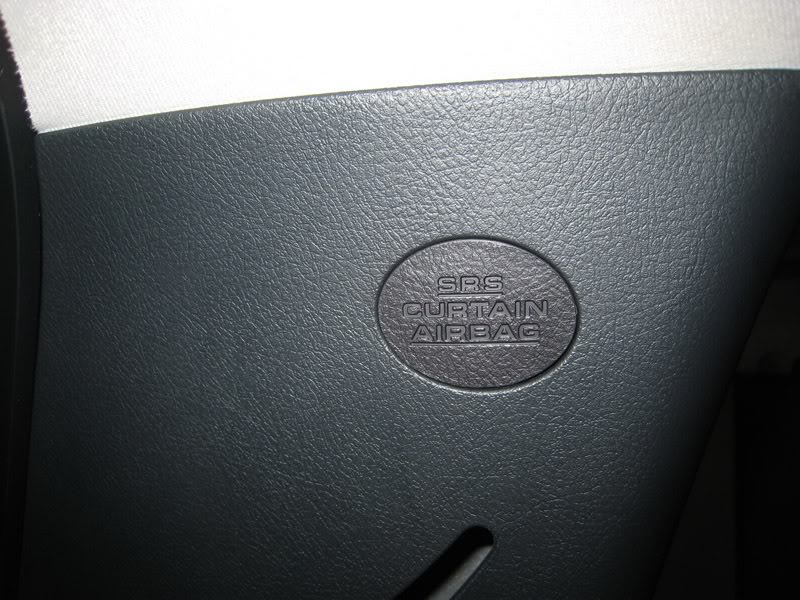 Locate the C-Pillar Bolt Step 6: Find the C-Pillar bolt under the SRS badge